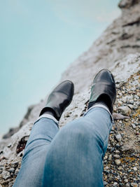 Low section of person wearing shoes on land