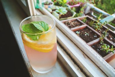 Lemonade in glass on window sill