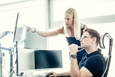 Portrait of smiling young woman exercising in office