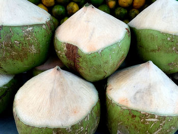 Close-up pile of semi-peeled coconut