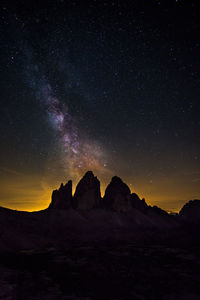 Scenic view of mountains against sky at night