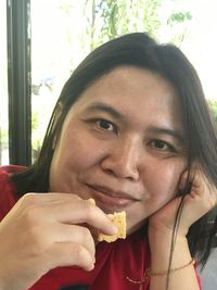 Close-up portrait of woman eating food