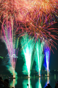 Firework display in river at night