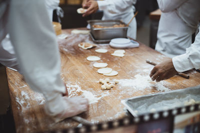 Midsection of man preparing food on table