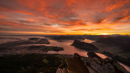 Scenic view of mountains against orange sky