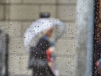 Full frame shot of wet glass window in rainy season