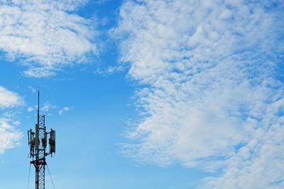 Low angle view of television tower against cloudy sky