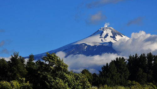 Low angle view of mountain against blue sky