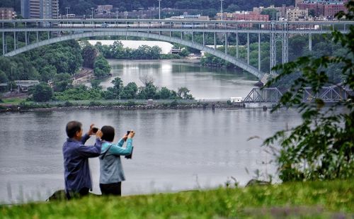 People photographing by river