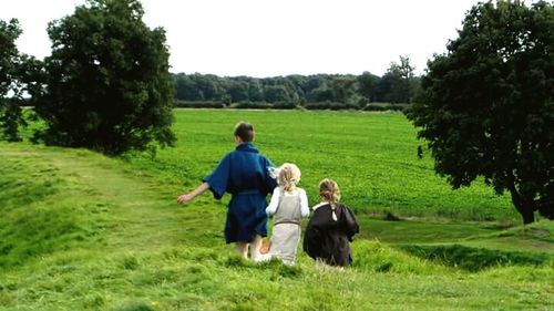 Rear view of father walking on field