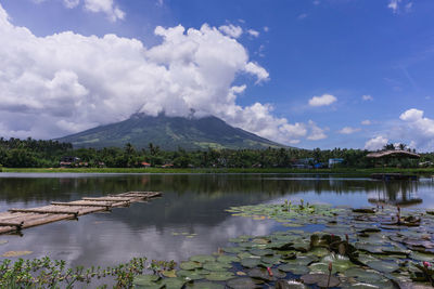 Scenic view of lake by mountains against sky