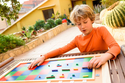 Boy playing checkerboard