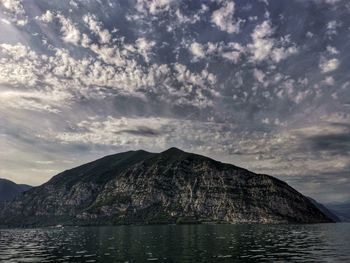 Scenic view of sea and mountains against sky