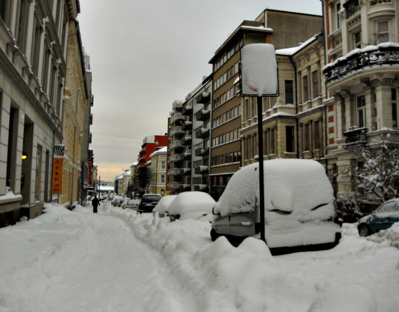 SNOW COVERED BUILDINGS AGAINST SKY