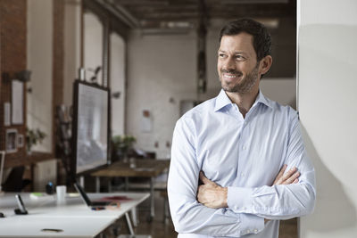 Portrait of smiling businessman in office