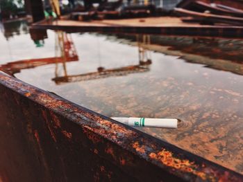 High angle view of cigarette butt floating in water