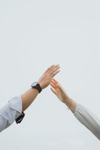 Cropped hand gesturing against white background