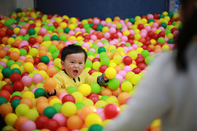 Close-up of boy playing with balloons