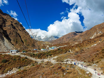 Scenic view of landscape and mountains against blue sky