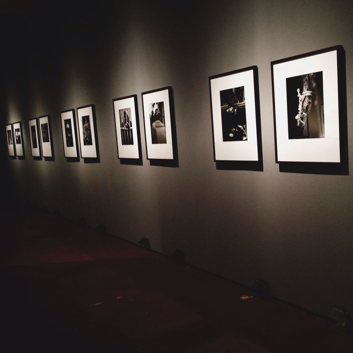 indoors, text, western script, illuminated, communication, empty, in a row, wall - building feature, no people, absence, built structure, door, architecture, window, wall, copy space, flooring, interior, side by side, reflection