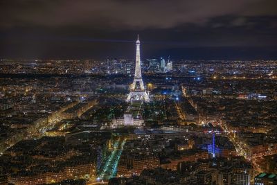 Aerial view of illuminated city buildings at night