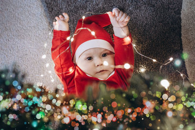 Portrait of cute baby girl with christmas tree