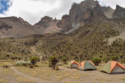 Campsite at a scenic view of rocky mountains against sky, mount kenya national park, kenya 
