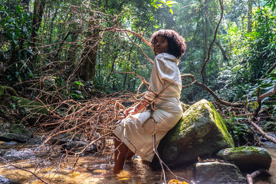 Side view of woman in forest