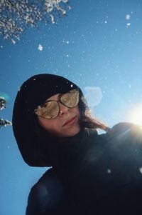 Portrait of man with sunglasses against sky during winter