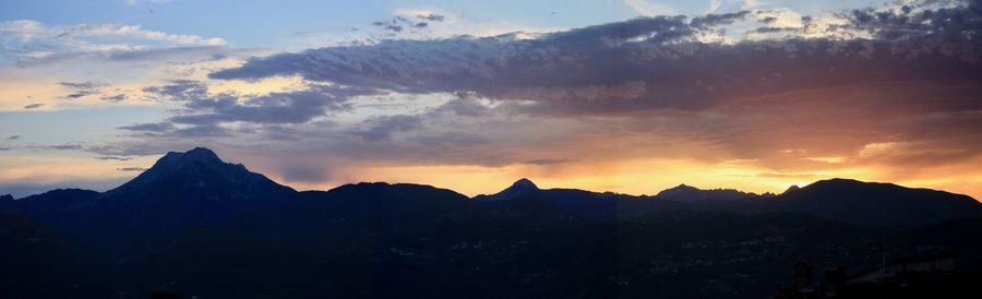 Scenic view of silhouette mountains against sky during sunset