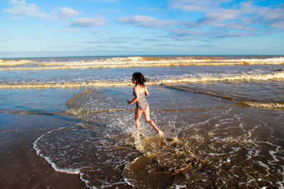 Girl running at shore