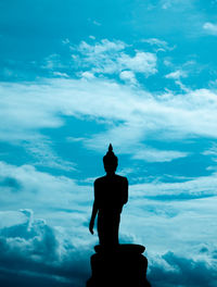 Low angle view of silhouette statue against sky