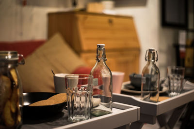 Close-up of glass and bottle on table