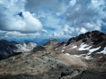 Idyllic view of mountains against cloudy sky during winter