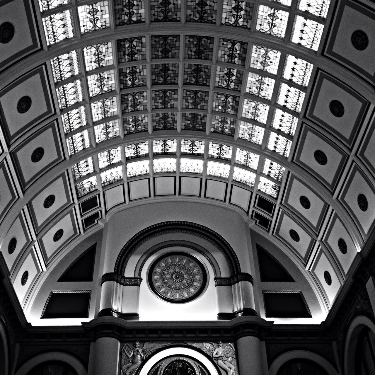 architecture, low angle view, indoors, built structure, ceiling, arch, architectural feature, pattern, dome, famous place, design, clock, circle, travel, window, church, directly below, history, no people, religion