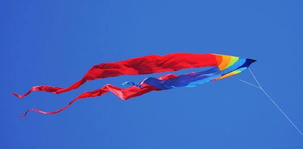 Low angle view of kite flying in clear sky