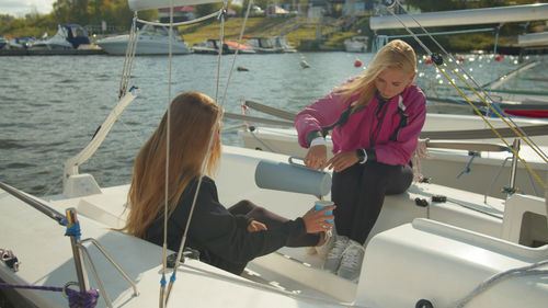 Friends sitting in sailboat