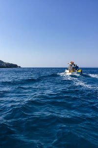 Scenic view of sea against clear blue sky