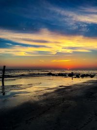 Scenic view of beach against sky during sunset