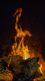 Wood burning on field at night