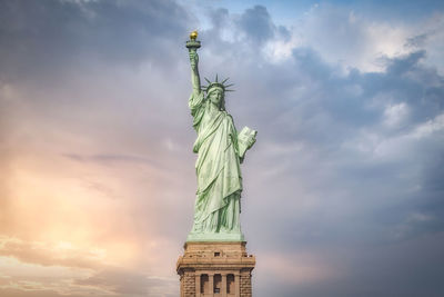 Low angle view of statue against cloudy sky