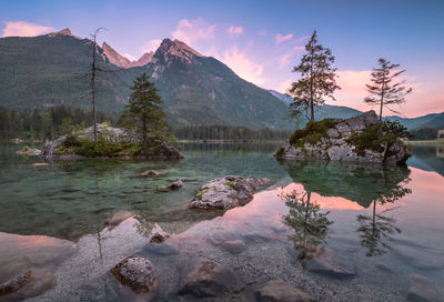 Scenic view of lake by mountains against sky