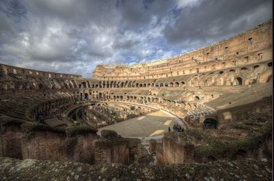 Exterior of coliseum against cloudy sky