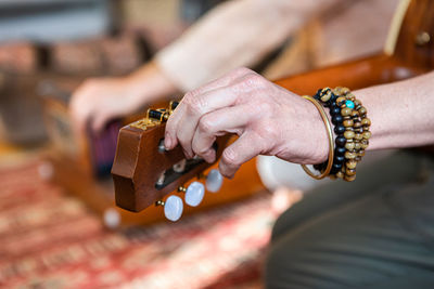 Close-up of woman playing guitar