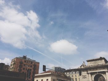 Low angle view of building against cloudy sky