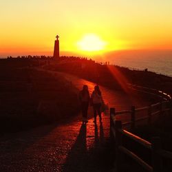 Silhouette of people at sunset