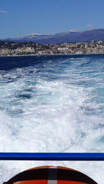 Swimming pool by sea against blue sky