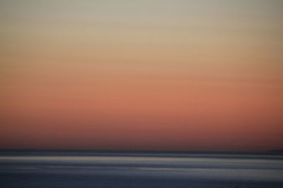 Scenic view of sea against romantic sky at sunset