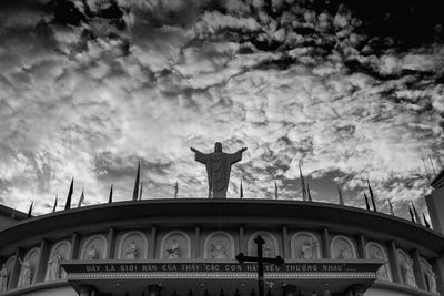 Low angle view of statue against bridge