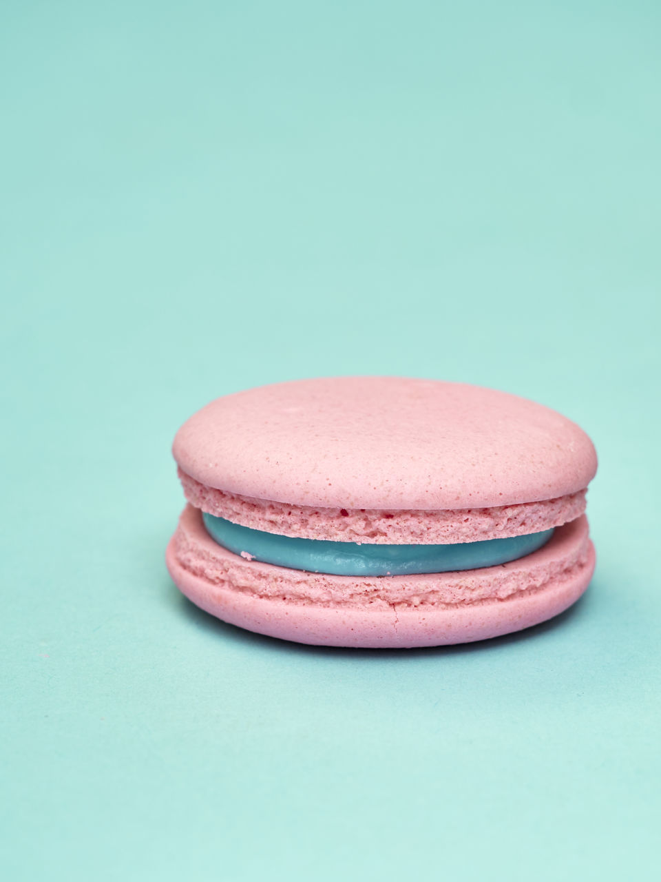 CLOSE-UP OF PINK CAKE AGAINST BLUE BACKGROUND